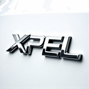 Authorized XPEL Installer. Certified professional smoothing out clear bra film on a luxury vehicle surface