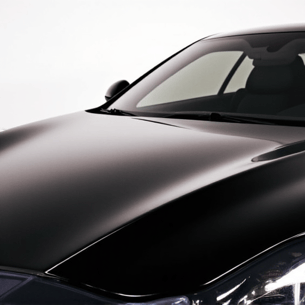 XPEL Paint Protection Film installation on a luxury car hood, showcasing precision alignment and seamless application by skilled technicians, ensuring paint integrity and protection against road debris, Tarzana, CA.